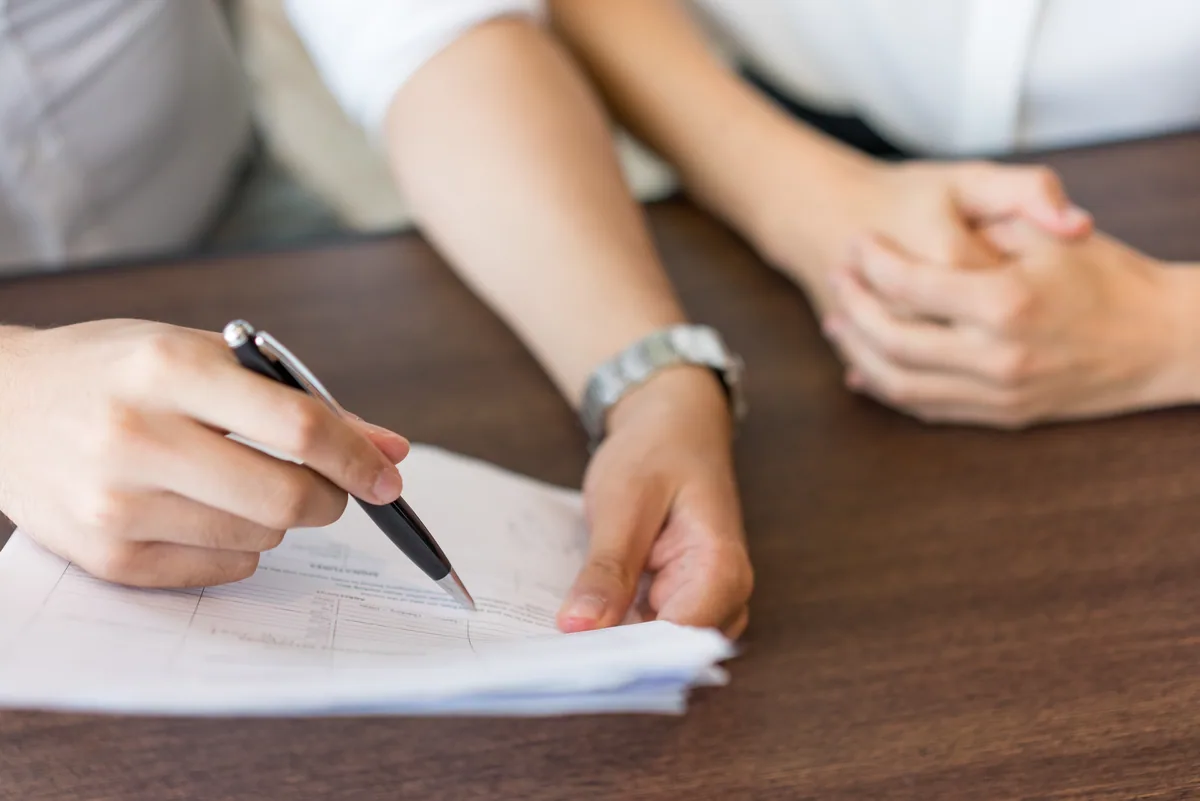 An adviser explaining a one-time Social Insurance claim to a foreign employee in Vietnam